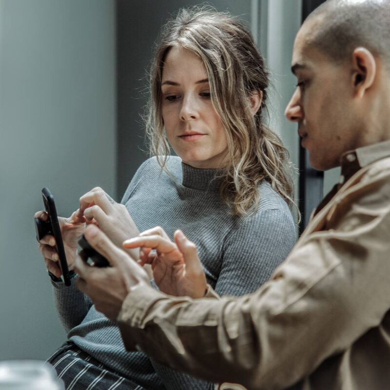 Blogpost IT-Sikkerhed. Kolleger diskutere IT-sikkerhed på telefon.