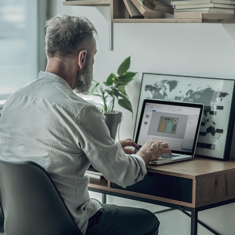 Blogpost om Articulate Storyline. Man sidder på hjemmekontor og arbejder.