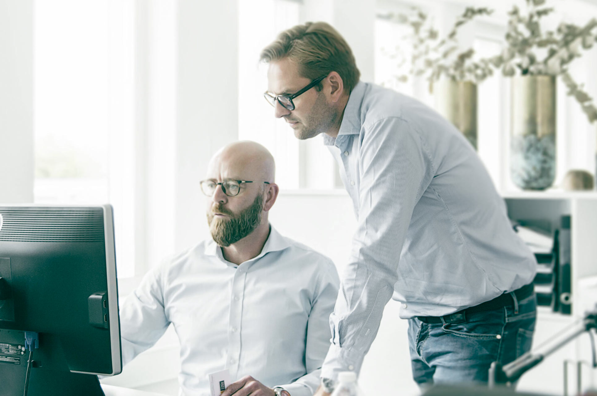 Manager helping colleague reviewing sales pitch