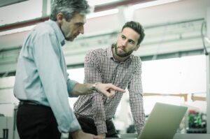 Young man receiving feedback from manager