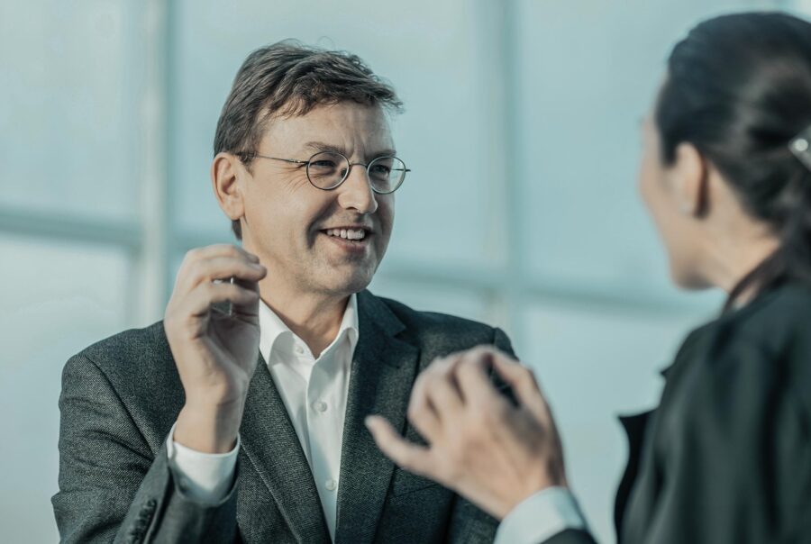 Professionals discussing their sales outside